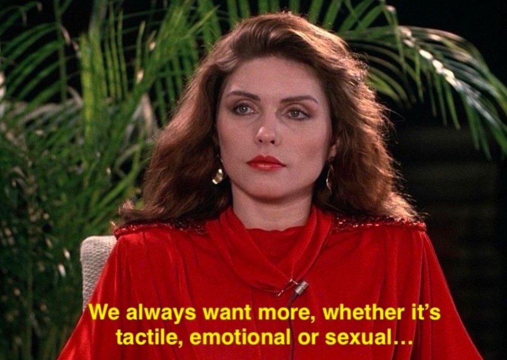 screenshot of Debbie Harry from the film Videodrome, directed by David Cronenberg, 1983. The text reads, "we always want more, whether it's tactile, emotional or sexual . . . 