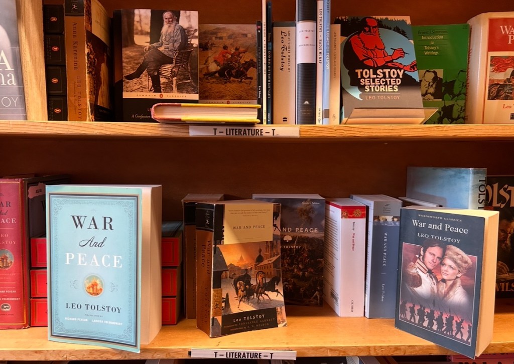 shelf of used copies of War and Peace and other books by Leo Tolstoy