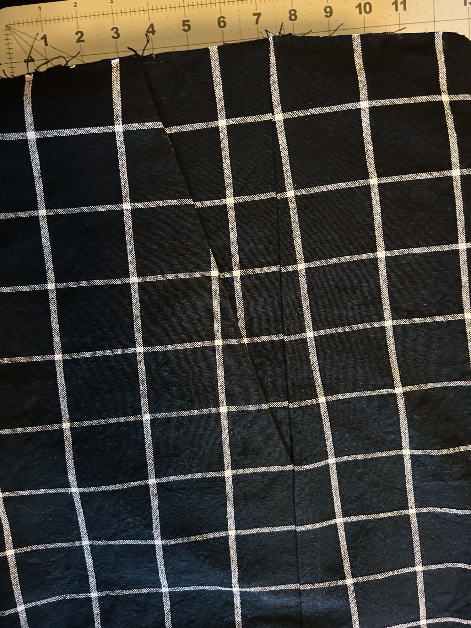 black yarn dyed fabric with white stripes, the photo shows the pocket bag attached to the front pant leg 